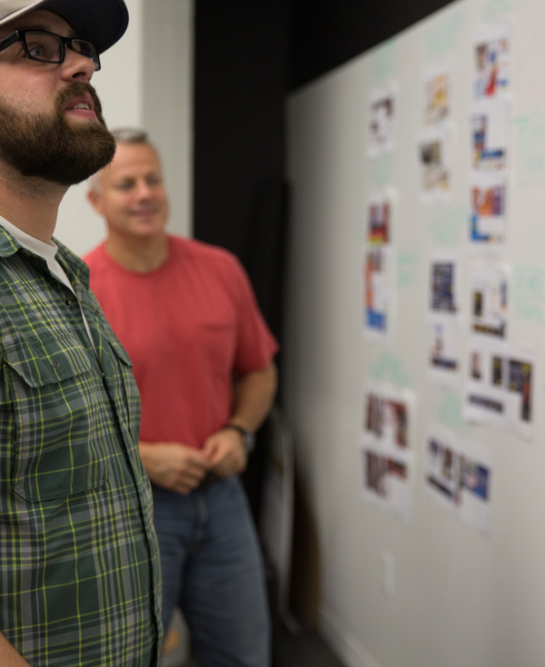 implementation methodology people looking at a storyboard.